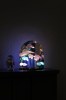 Space-table-lamp-on-cabinet-in-dark-pastel-light